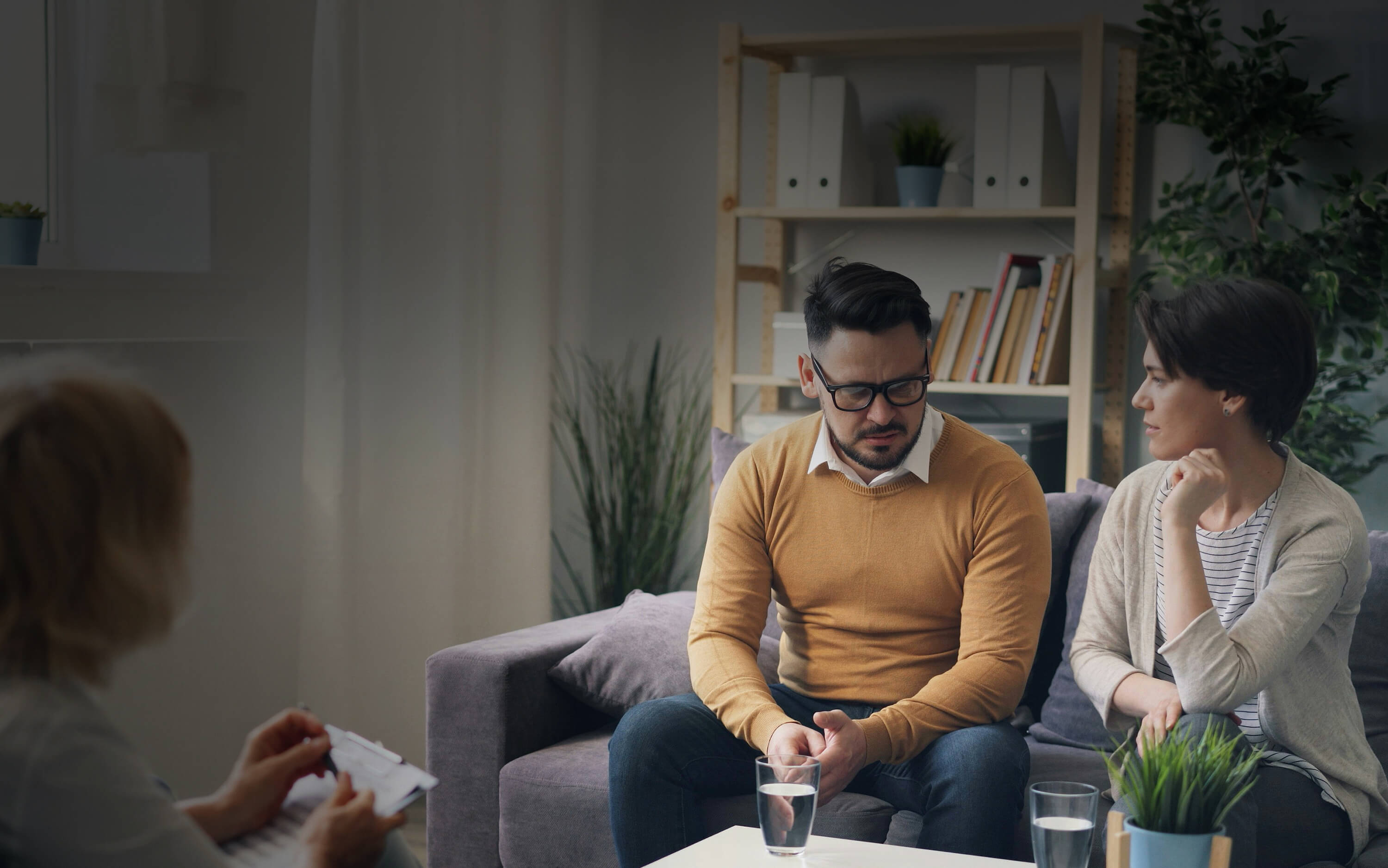 Man and woman sitting in a room receiving counselling