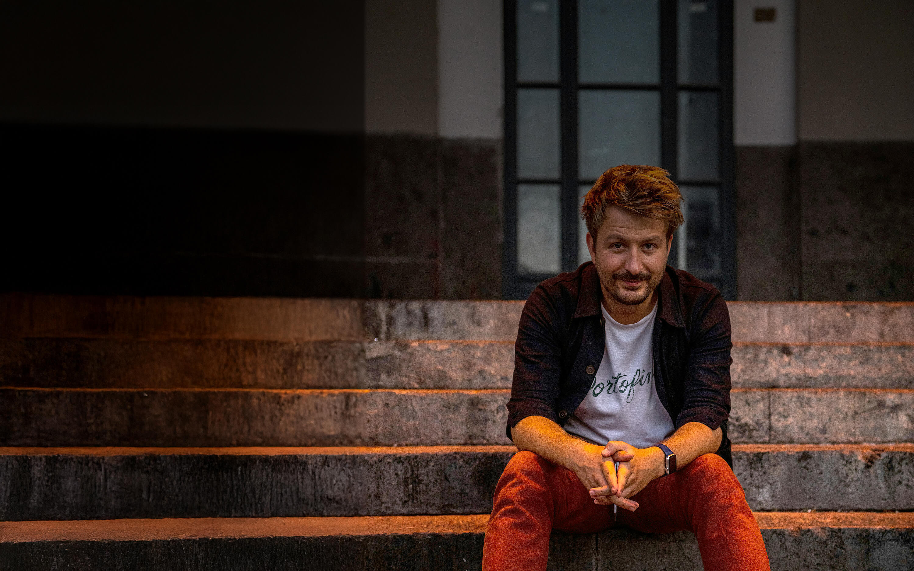 Middle-aged man sitting and smiling