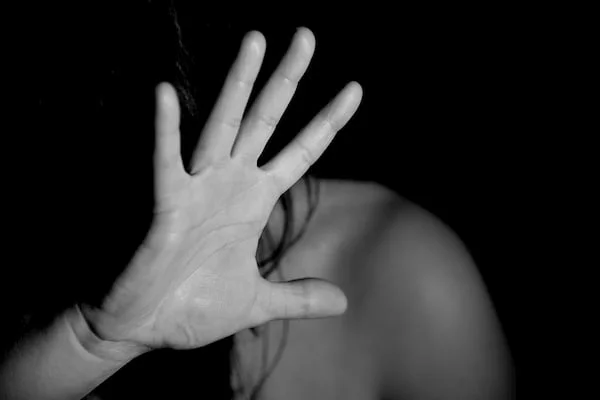 Woman raising her hand to protect herself