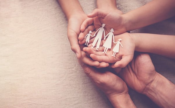 CAFS - How we care Hands holding paper family cutout
