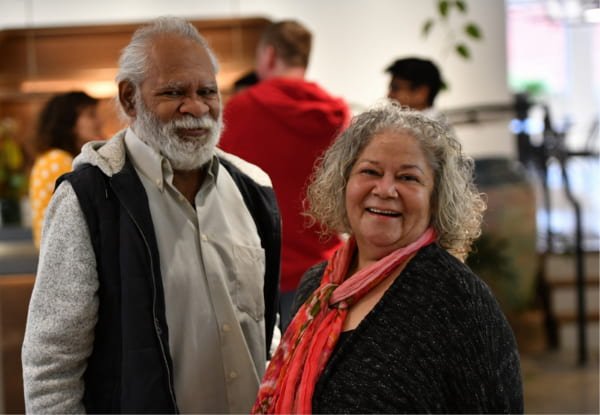 Aboriginal Man and woman smiling at the camera