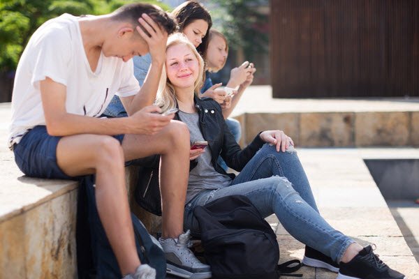Group of teenagers communicate in public - youth support