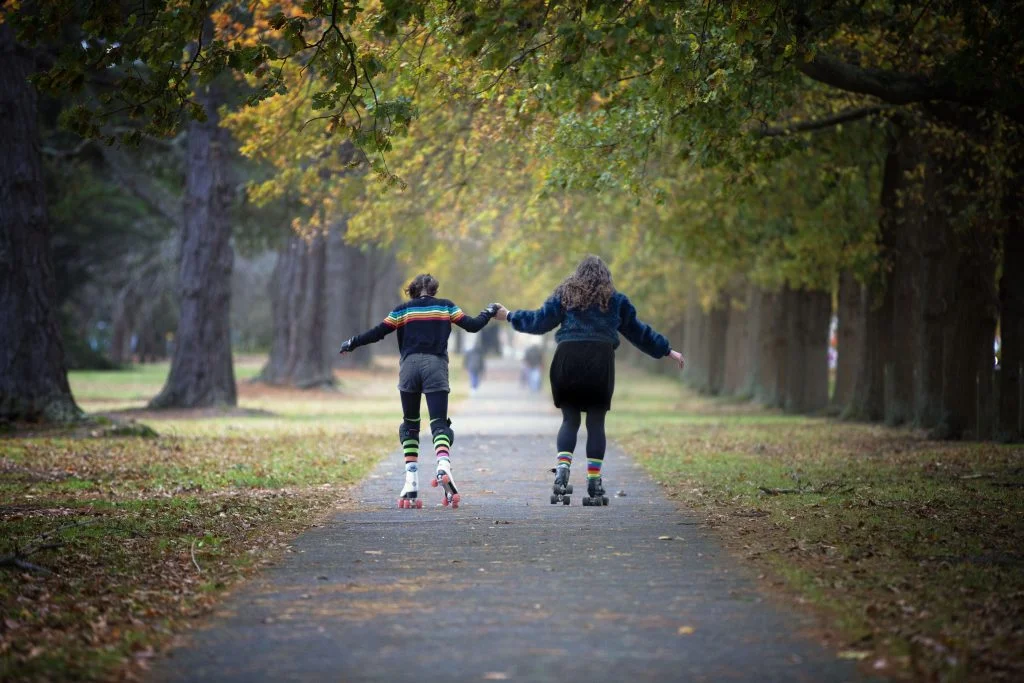 Foster care mother and foster daughter skating in the park