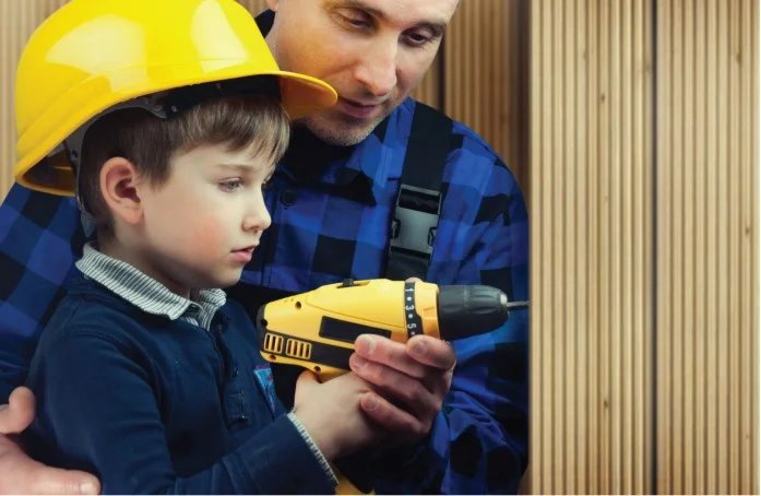 Little boy is playing with his Dad's Tool Kit