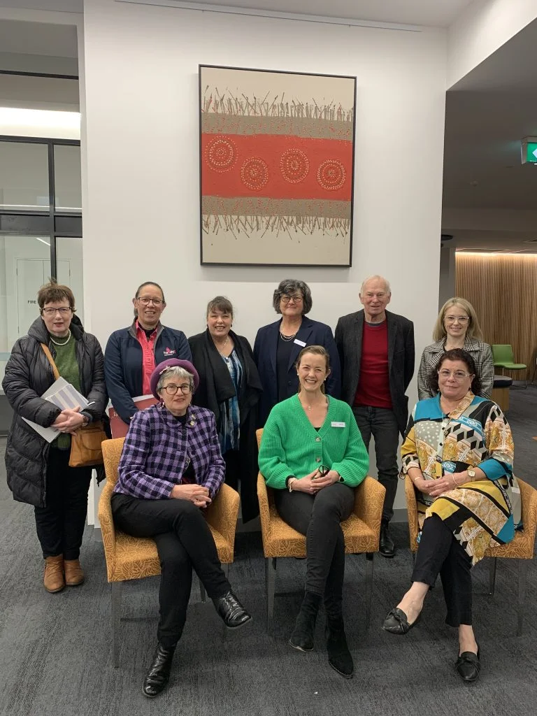 Group of people sitting and smiling at the camera