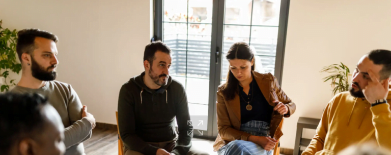 Group of people sitting in a circle having a discussion