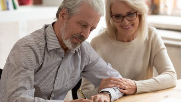 Cafs-Happy-older-family-couple-husband-and-wife-sign-legal-paper Cafs-Happy-older-family-couple-husband-and-wife-sign-legal-paper